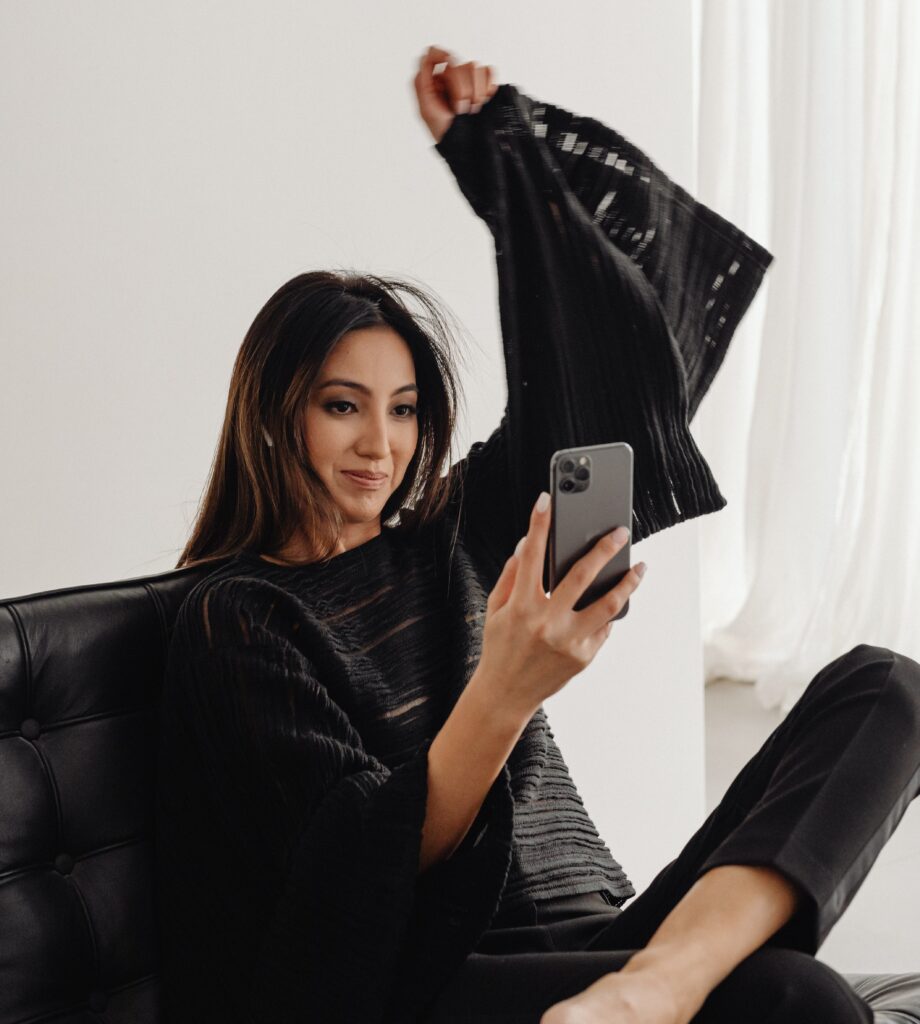 kaboompics_dark-classy-aesthetic-fashion-beautiful-asian-female-entrepreneur-in-black-suit-technology-and-devices-iphone-laptop-airpods-30023 (1)